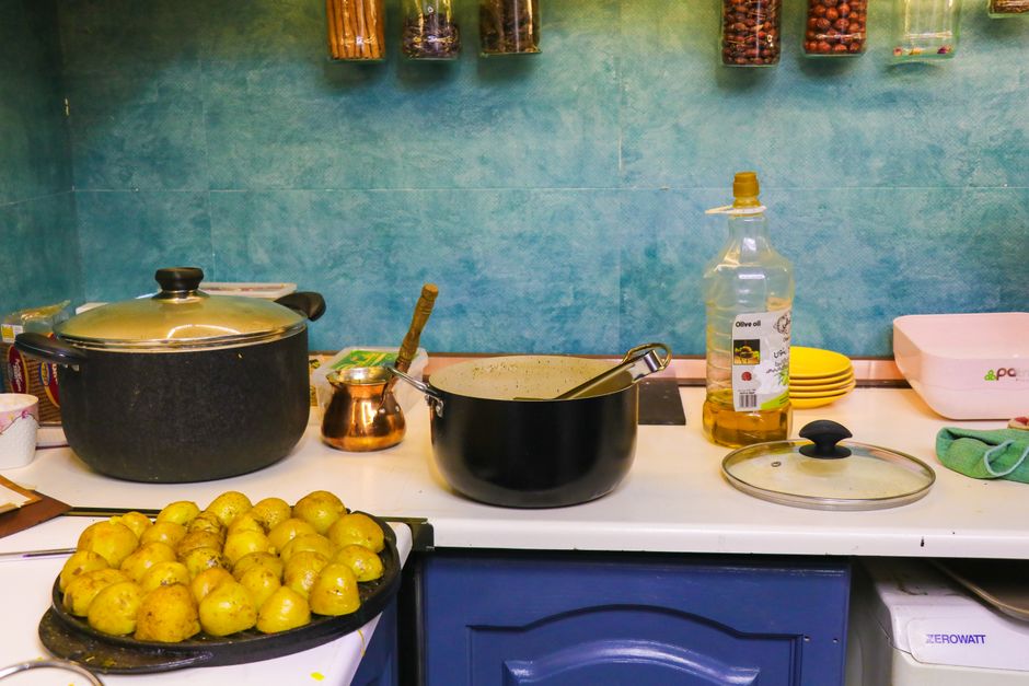 Home kitchen scene with cooking pots, potatoes, and spices. Ideal for cooking and lifestyle themes.